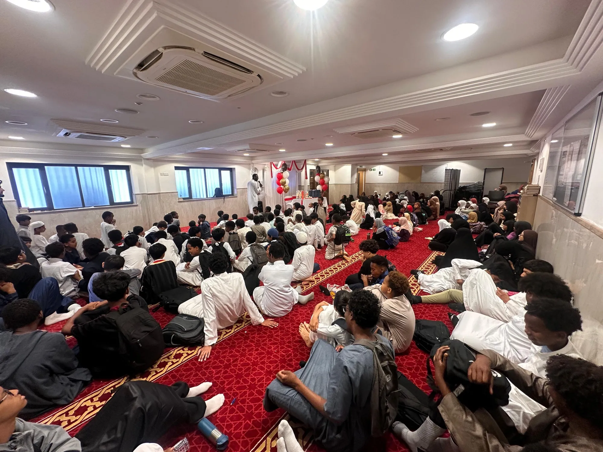 Students and families gathered in the masjid for an academy event